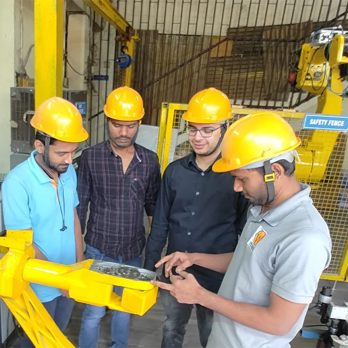 IRATI trainees working hands-on on an industrial robot arm