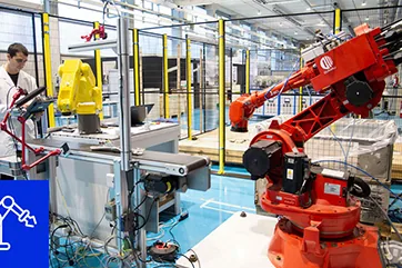 A robot integrated with conveyors and surrounding line equipment.
